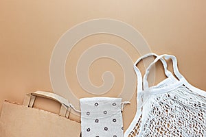 Paper and cotton bag and reusable mesh for free plastic shopping on a brown background