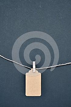 Paper craft discount labels are attached with clothespins to the rope on a black background.