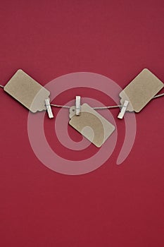 Paper craft discount labels are attached with clothespins to the rope on a red background.