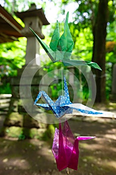 A paper crane swaying in the wind at the traditional street