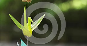 A paper crane swaying in the wind at the traditional street close up handheld