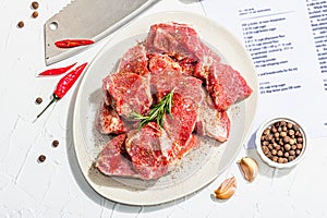 Paper culinary recipe for preparation pork. Raw ingredients includes pork loin pieces, spices, herbs