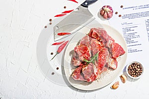 Paper culinary recipe for preparation pork. Raw ingredients includes pork loin pieces, spices, herbs