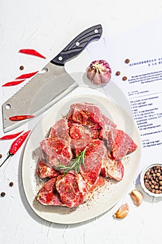 Paper culinary recipe for preparation pork. Raw ingredients includes pork loin pieces, spices, herbs