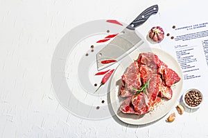 Paper culinary recipe for preparation pork. Raw ingredients includes pork loin pieces, spices, herbs