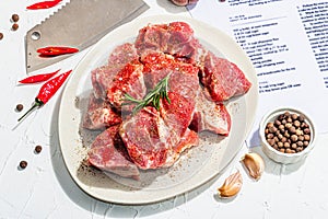 Paper culinary recipe for preparation pork. Raw ingredients includes pork loin pieces, spices, herbs