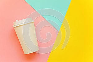 Paper cup of coffee on colorful background