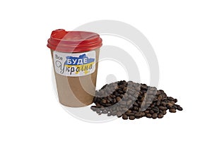 A paper cup of coffee with a patriotic sticker and a handful of roasted coffee beans isolated on a white background