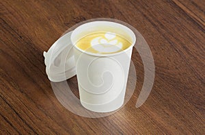 Paper cup of Coffee take-away, top viewon wooden table