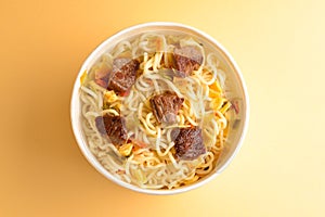 Paper cup with instant ramen noodles with beef and vegetables