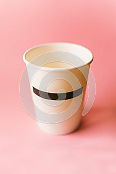 Paper cup on pink background
