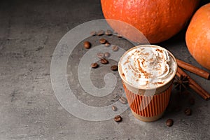 Paper cup with tasty pumpkin spice latte and space