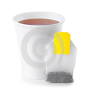 Paper cup with tea and tea bag isolated on white