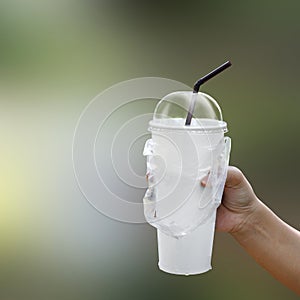 Paper cup white blank and straws in hand, fast food cup plastic for water drink, white cup plastic and straws is waste