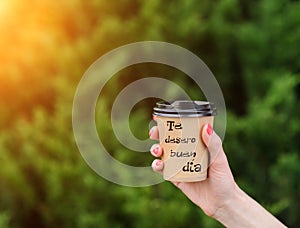 paper cup witn wrotten word on it