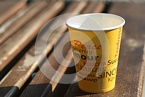 Paper cup on the wooden bench photo