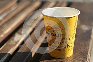 Paper cup on the wooden bench photo