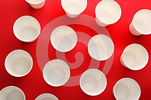 Paper cups on color background, top view
