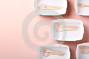 Paper cups, dishes, bag, wooden forks, drinking straws, fast food containers, wooden cutlery on pink background. Eco craft paper t