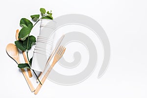 Paper cups, wooden fork, spoon, knife, tube, on white background