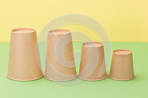 Paper cups in yellow and green background