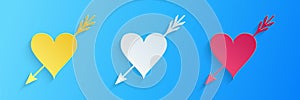 Paper cut Amour symbol with heart and arrow icon isolated on blue background. Love sign. Valentines symbol. Paper art