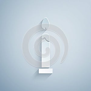 Paper cut Burning candle icon isolated on grey background. Cylindrical candle stick with burning flame. Paper art style