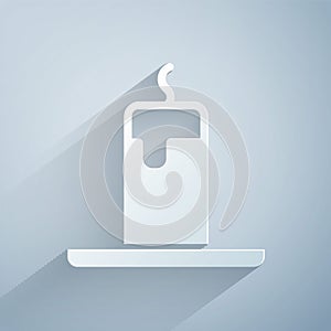 Paper cut Burning candle icon isolated on grey background. Cylindrical candle stick with burning flame. Paper art style