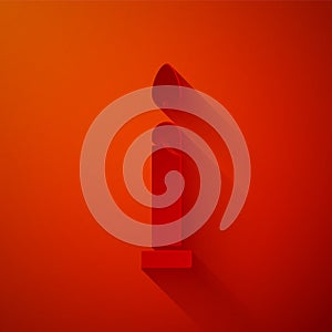 Paper cut Burning candle icon isolated on red background. Cylindrical candle stick with burning flame. Paper art style