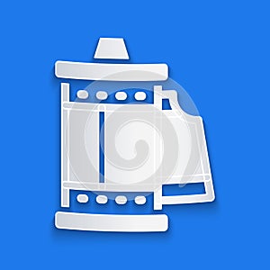 Paper cut Camera vintage film roll cartridge icon isolated on blue background. 35mm film canister. Filmstrip