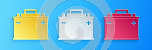 Paper cut Car battery icon isolated on blue background. Accumulator battery energy power and electricity accumulator