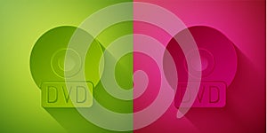 Paper cut CD or DVD disk icon isolated on green and pink background. Compact disc sign. Paper art style. Vector