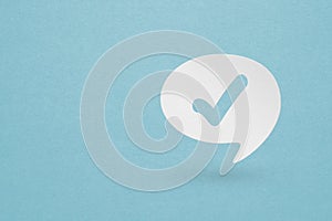 Paper cut Check mark in bubble speech icon isolated on grunge blue background. Choice button sign. Checkmark symbol. Speech bubble