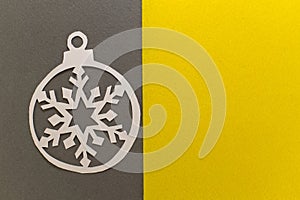 Paper cut Christmas ball on grey yellow background