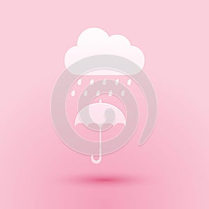 Paper cut Cloud with rain drop on umbrella icon isolated on pink background. Paper art style. Vector