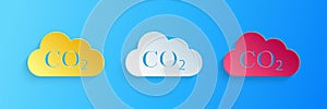 Paper cut CO2 emissions in cloud icon isolated on blue background. Carbon dioxide formula symbol, smog pollution concept