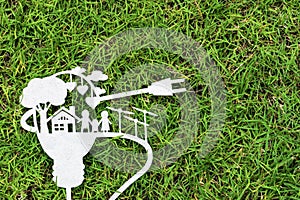 Paper cut of eco on green grass. Stories about energy saving.