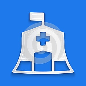 Paper cut Emergency medical tent icon isolated on blue background. Provide disaster relief. Paper art style. Vector
