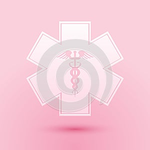 Paper cut Emergency star - medical symbol Caduceus snake with stick icon isolated on pink background. Star of Life