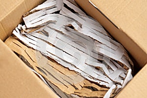 Paper cut filler in cardboard box for parcel shipments of fragile orders close up