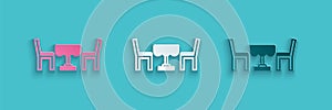 Paper cut French cafe icon isolated on blue background. Street cafe. Table and chairs. Paper art style. Vector
