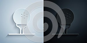 Paper cut Golf ball on tee icon isolated on grey and black background. Paper art style. Vector