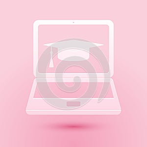 Paper cut Graduation cap and laptop icon isolated on pink background. Online learning or e-learning concept icon. Paper