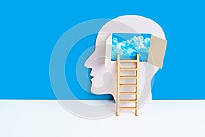 Paper-Cut Head with Ladder and Mind Window to Gloomy Cloudscape