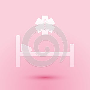 Paper cut Hospital Bed with Medical symbol of the Emergency - Star of Life icon isolated on pink background. Flat design. Paper