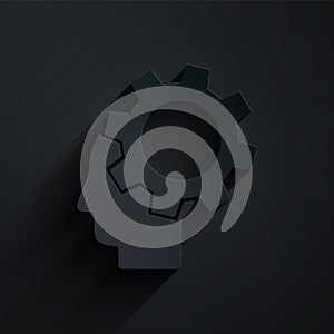 Paper cut Human head with gear inside icon isolated on black background. Artificial intelligence. Thinking brain. Symbol