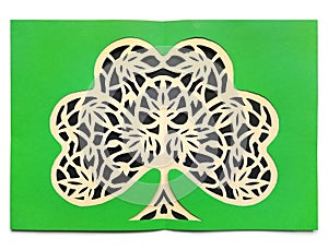 Paper cut illustration of green clover shamrock made by hand. Openwork with plant leaves Irish papercraft art