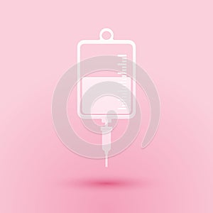 Paper cut IV bag icon isolated on pink background. Blood bag icon. Donate blood concept. The concept of treatment and