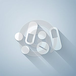 Paper cut Medicine pill or tablet icon isolated on grey background. Capsule pill and drug sign. Pharmacy design. Paper