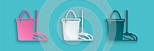 Paper cut Mop and bucket icon isolated on blue background. Cleaning service concept. Paper art style. Vector